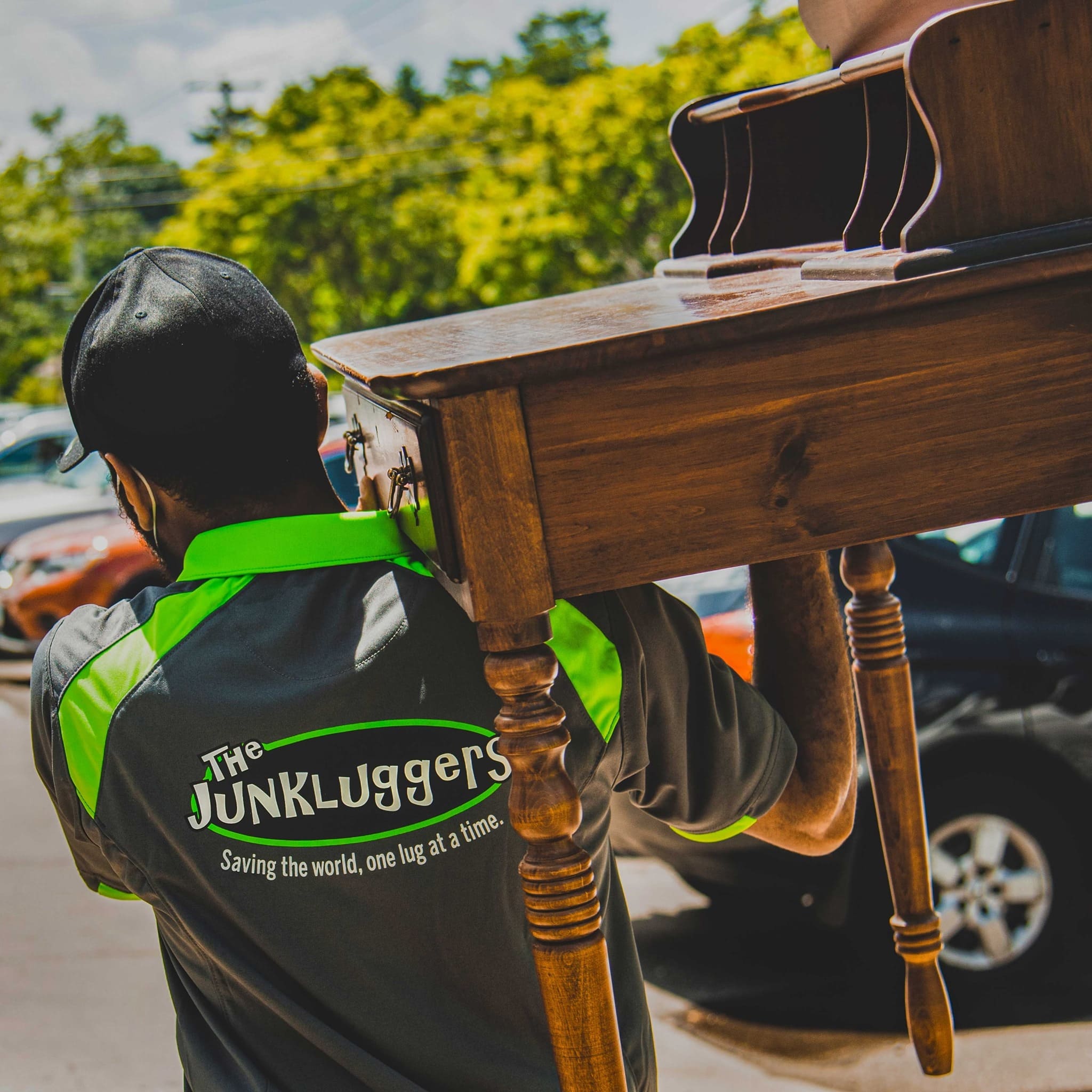 Man carrying a desk over his shoulder