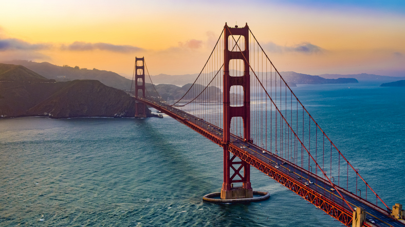 San Francisco bridge with water under it during the sunset